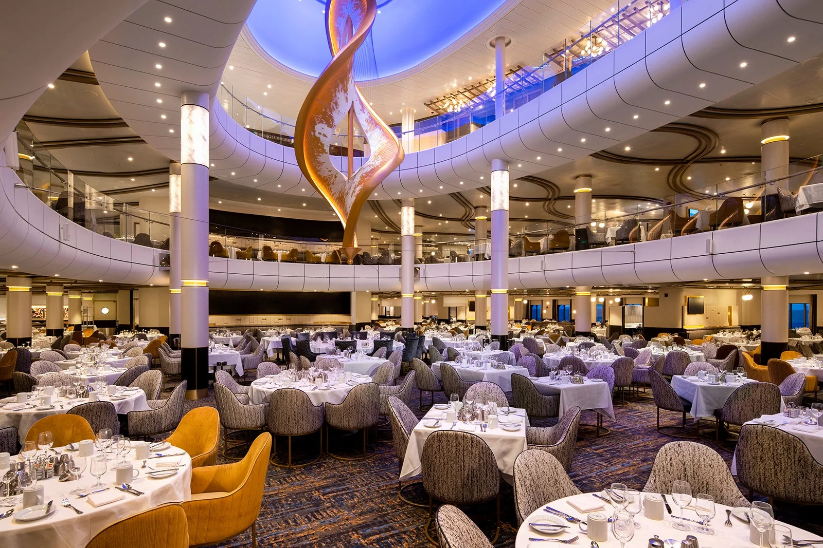 The main dining room aboard a Royal Caribbean ship at dusk