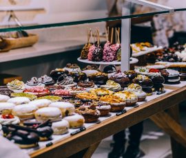 Europe A tempting display of various donuts and pastries in a bakery. Ideal for food lovers and culinary enthusiasts.